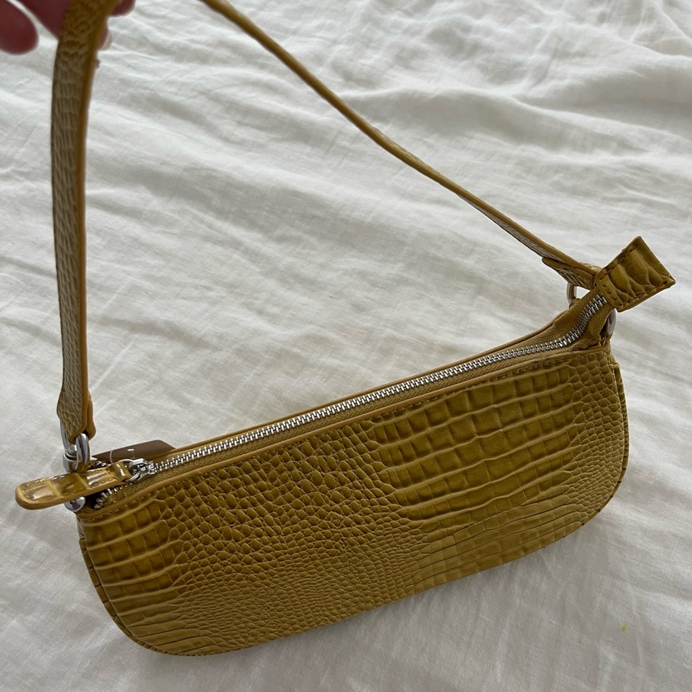 NWT urban outfitters mustard yellow pocket book. Never used.